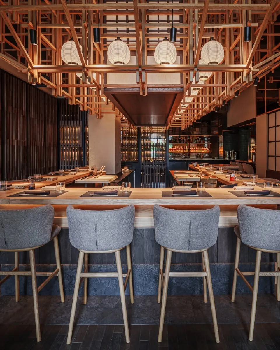 The omakase counter and its lattice ceiling seen from the dining room