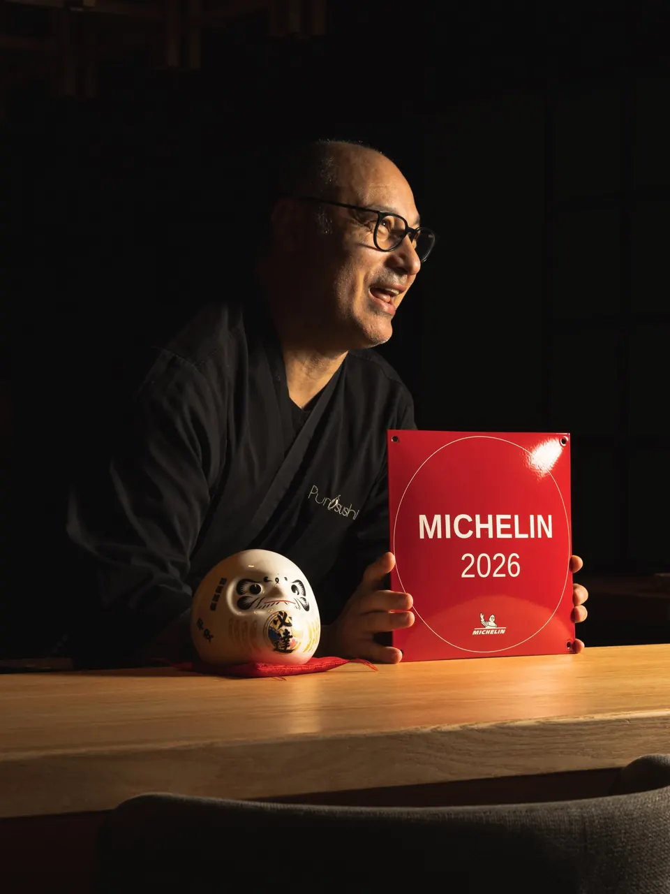 At the PurOsushi counter with the MICHELIN Guide 2026 plaque